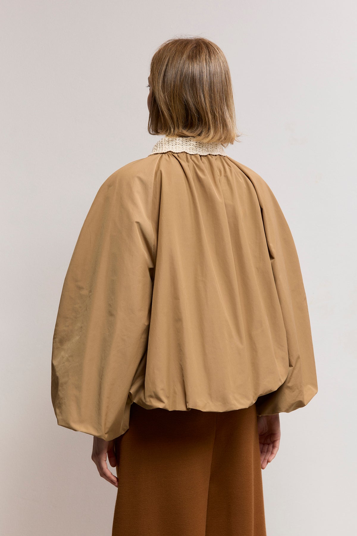 Woven trench with textured knit neck