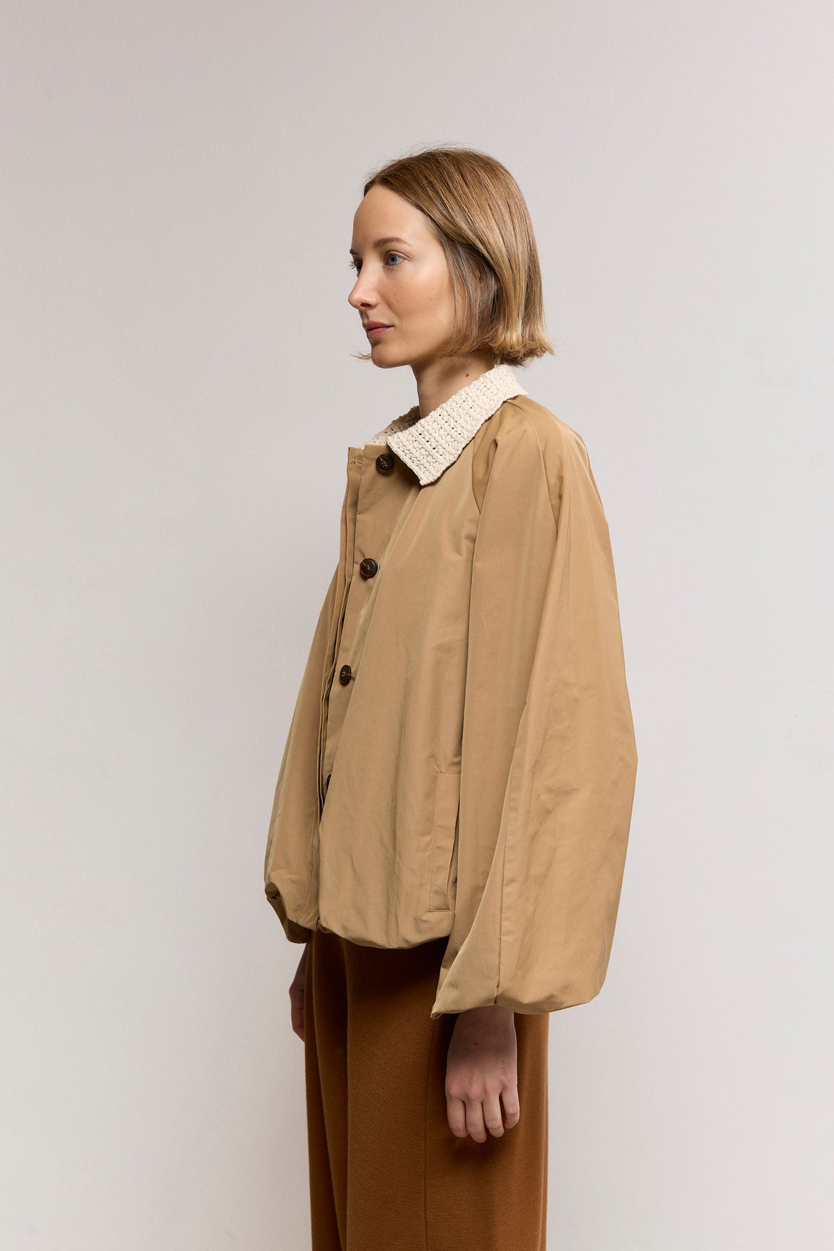 Woven trench with textured knit neck